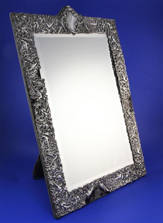 A large late Victorian repousse silver mounted easel mirror, by William Comyns, 23.25in.